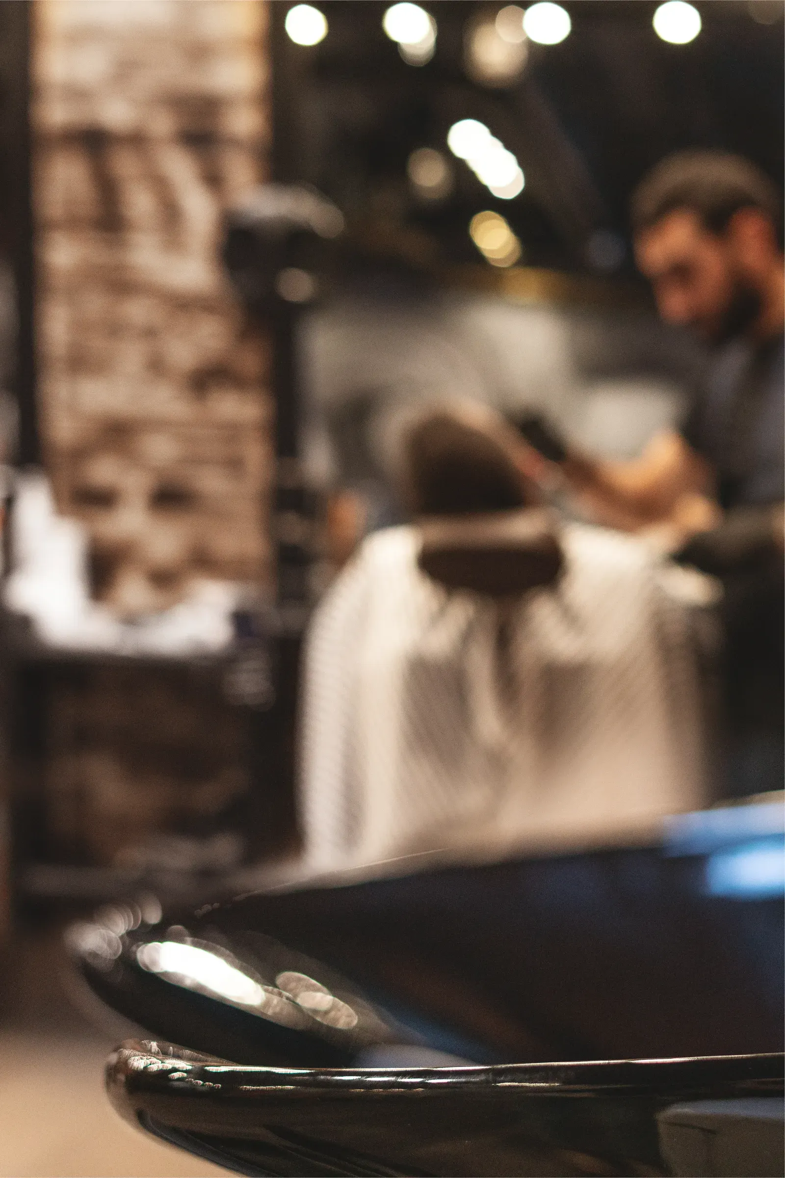 Barber detailing a taper haircut in a working barbershop